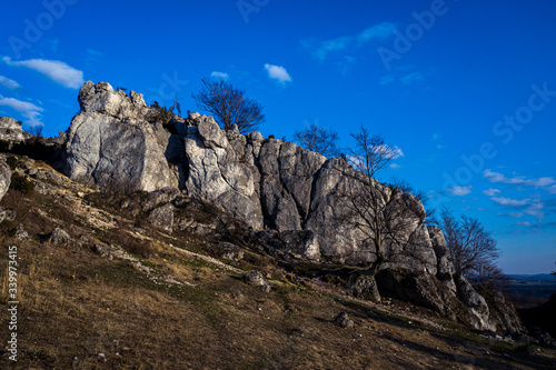 Top down view/ Aerial view over limestone rocks on the Mountain Kołoczek in Podlesice (Upland Cracow - Czestochowa, Wyzyna Krakowsko - Czestochowska), popular tourist place. During sunny early spring 