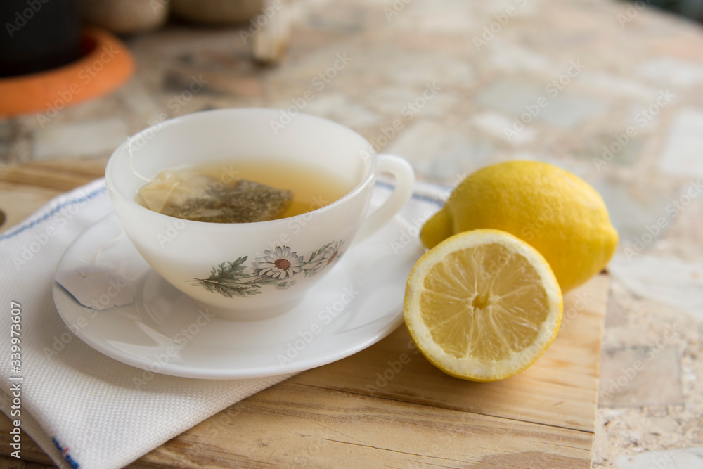 cup of chamomile tea with lemon on a neutral background cup of chamomile tea with lemon on a neutral background