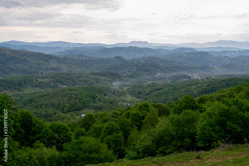 High mountains with blue sky and green forest