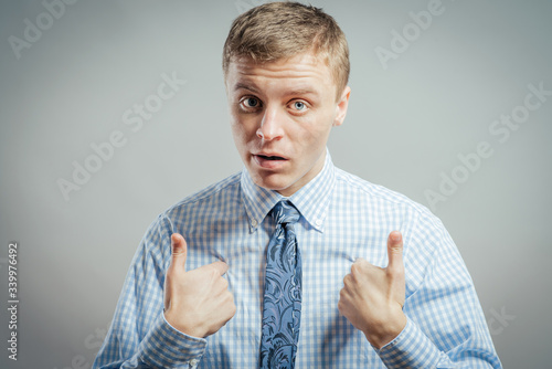 Fotografie Closeup portrait of angry, unhappy, annoyed young man, getting mad, asking question: you talking to me, you mean me? Isolated on white background