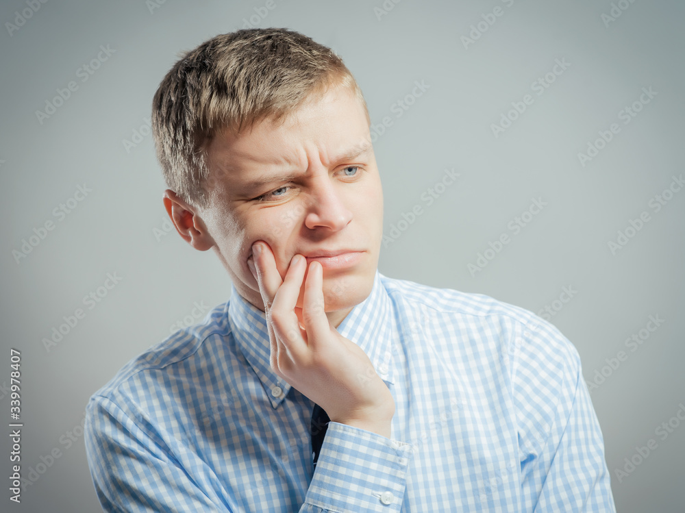 a young man with a toothache a young man with a toothache