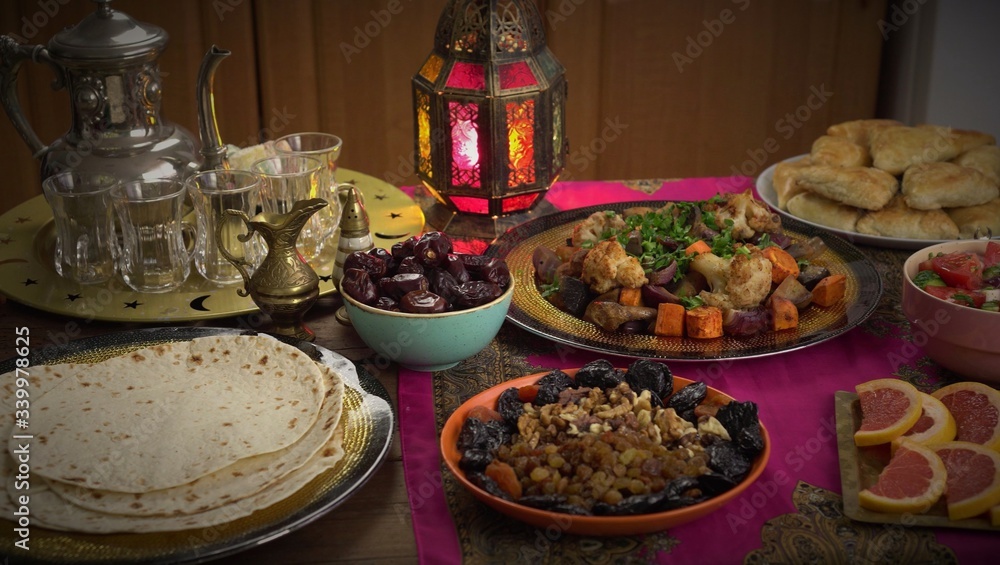 Ramadan Fasting, Iftar food. Muslim people gathering to break their fast together. The meal is taken just after the call to prayer Maghrib, which is around sunset. Middle Eastern cuisine