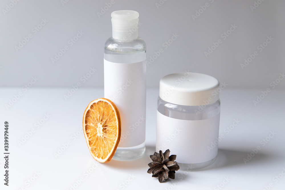 Cosmetic bottle for liquid, cream, gel, lotion. Hand sanitizer. Organic natural science beauty product. Battle with slice of orange Cosmetic bottle for liquid, cream, gel, lotion. Hand sanitizer. Organic natural science beauty product. Battle with slice of orange