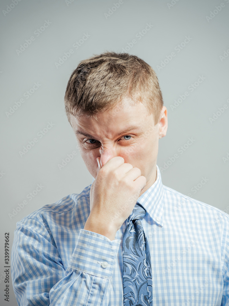 young man blows his nose into a handkerchief young man blows his nose into a handkerchief