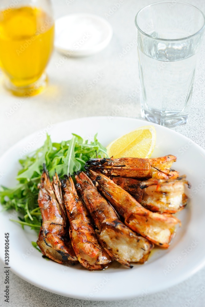 Grilled Shrimp with lemon on the plate - Close-up