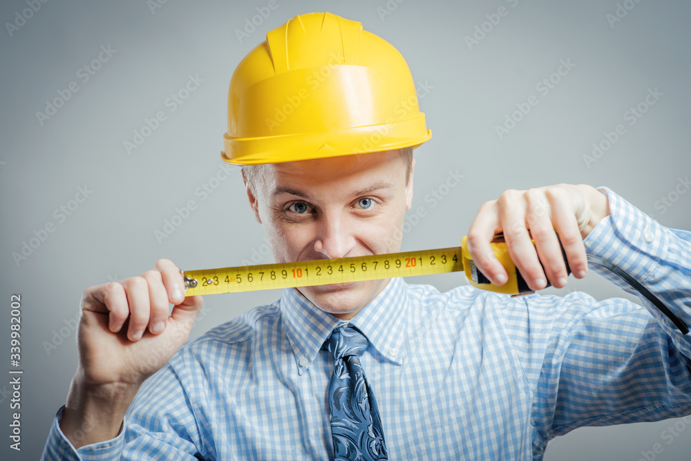 young builder with yellow tape measure young builder with yellow tape measure