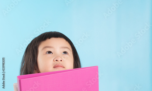 Cute Asian girls are holding a file folder for new ideas.