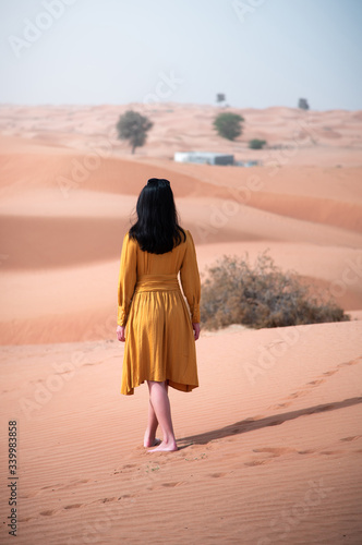 Woman walking in a desert back view