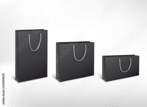 Set of black paper different size bags. Clean blank pack for purchases with white rope handles for design or text. High resolution 3d illustration. Isolated on white background. 