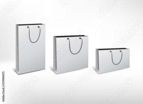 Set of white different size paper bags. High realistic illustration. Isolated on white background. 