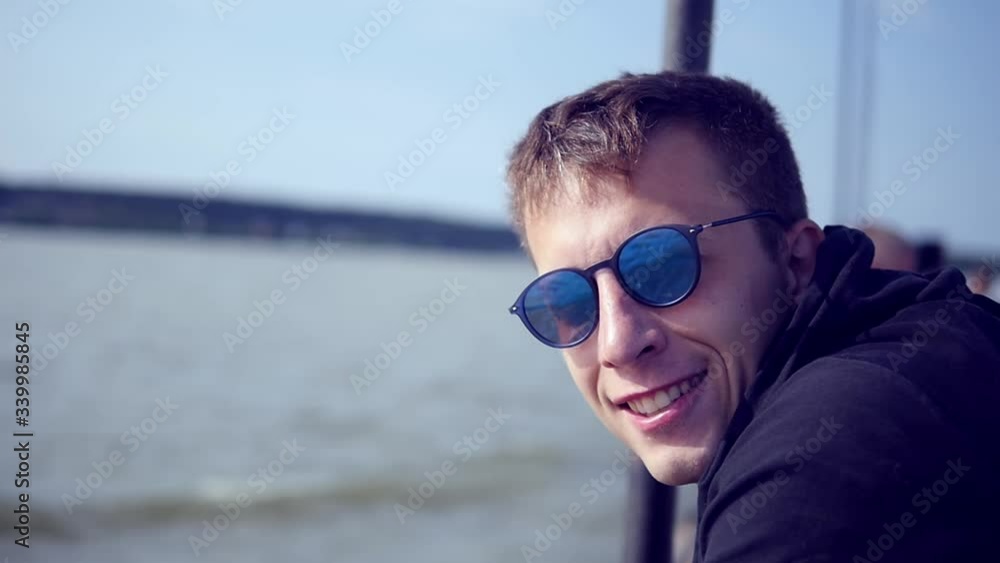 Close up portrait of handsome young man looking thoughtful pensive on seaside background focused confident Close up portrait of handsome young man looking thoughtful pensive on seaside background focused confident