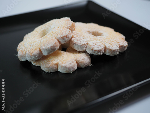 three cookies on a black plate photo