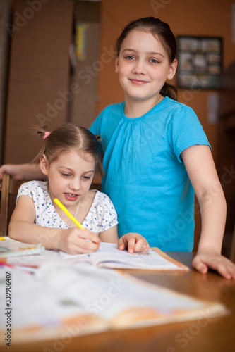 Older sister helping   younger sister with her studies