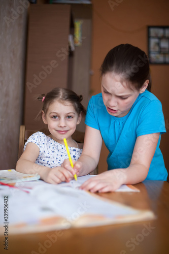 Older sister helping   younger sister with homework