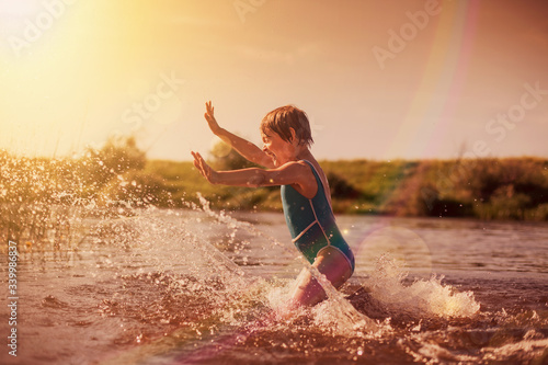  little girl  swimming in   warm river. © DariaTrofimova