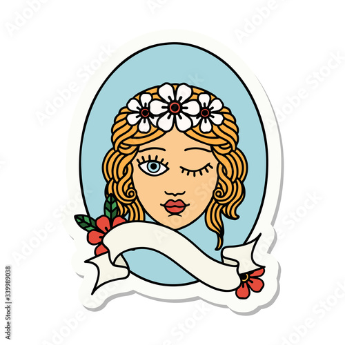 tattoo sticker with banner of a maiden with crown of flowers winking