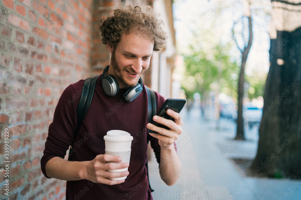 Young man using his mobile phone. Young man using his mobile phone.