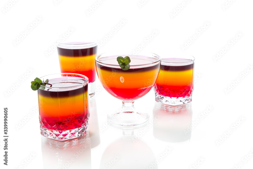 Sweet multi-colored fruit puff jelly in a glass cup Sweet multi-colored fruit puff jelly in a glass cup
