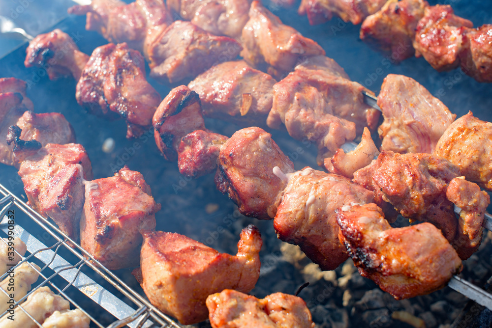 fresh juicy shish kebab is fried on coals on a barbecue in the backyard fresh juicy shish kebab is fried on coals on a barbecue in the backyard