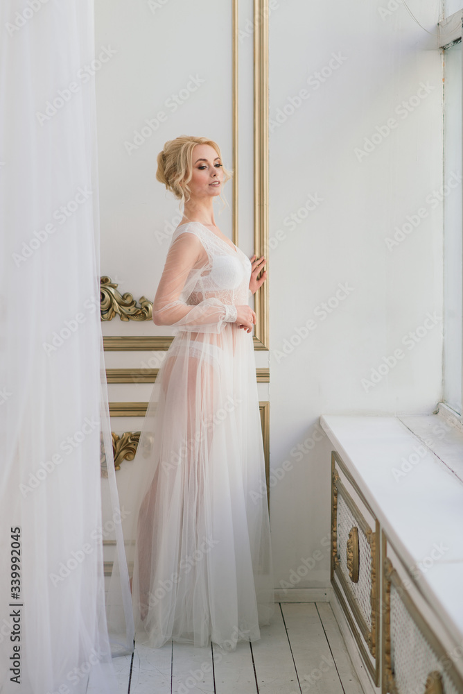 Conceptual wedding, the morning of the bride in the European style. Boudoir dress, fees in the interior Studio. White minimalism for the bride Conceptual wedding, the morning of the bride in the European style. Boudoir dress, fees in the interior Studio. White minimalism for the bride