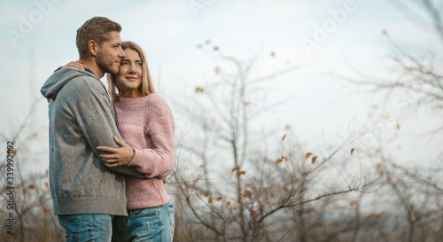 Positive People Hugging On Sky And Autumn Trees Back