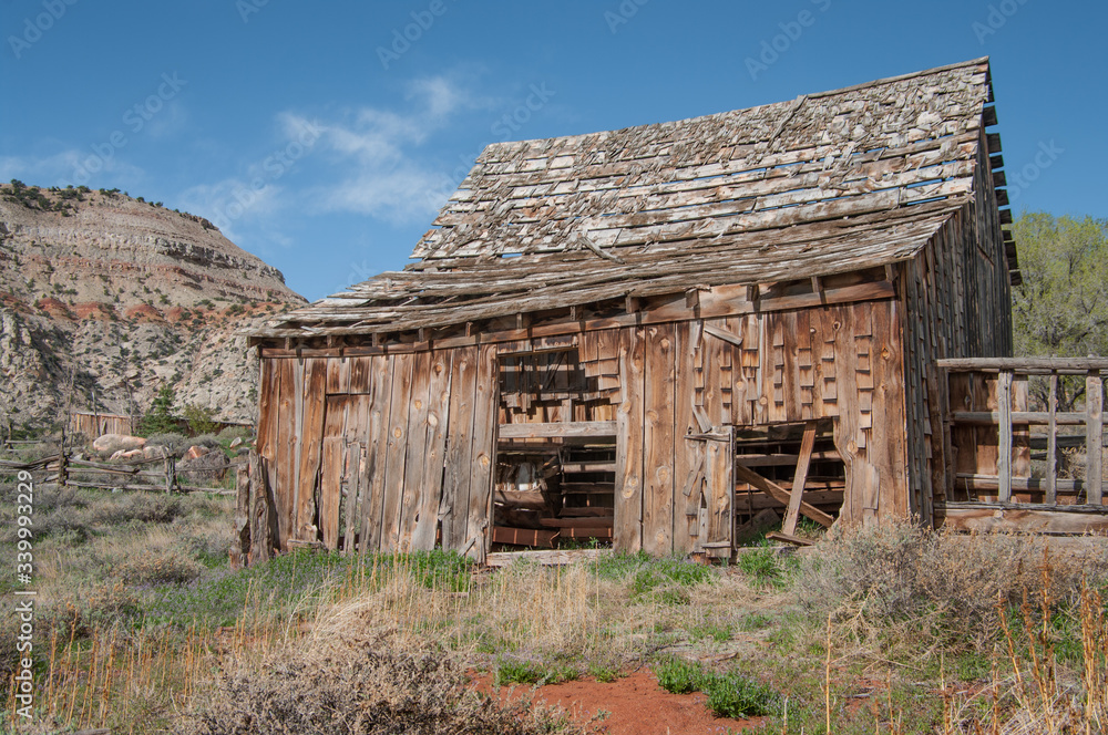 Old Wooden Barn: A barn with missing shingles and side boards weathers in the sunshine of southern Utah.
Old Wooden Barn: A barn with missing shingles and side boards weathers in the sunshine of southern Utah.