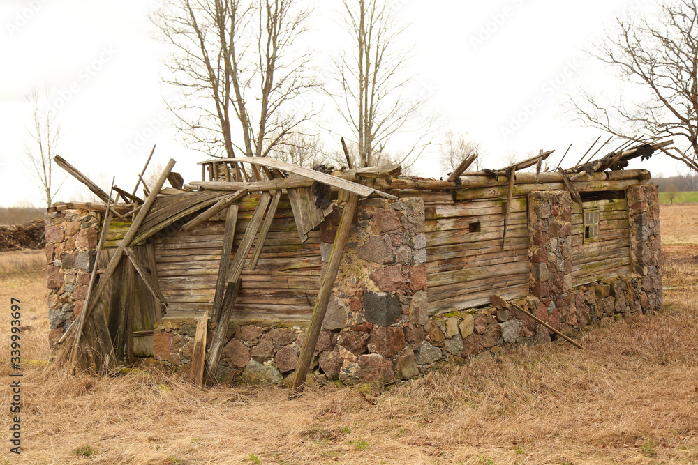 Old stone barn almost fallen with wooden roof top cover Old stone barn almost fallen with wooden roof top cover