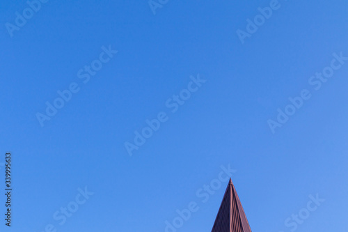 The cone tower against a clear blue sky without clouds.