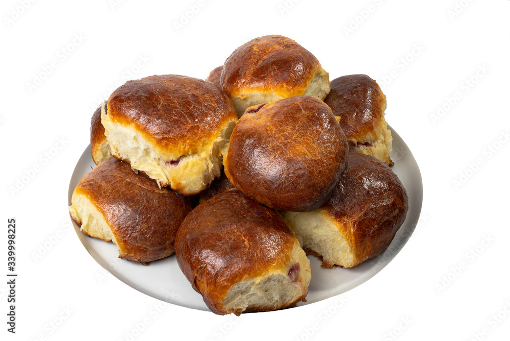 Sweet buns on a dish. Baked hot homemade buns. Isolated on a white background Sweet buns on a dish. Baked hot homemade buns. Isolated on a white background