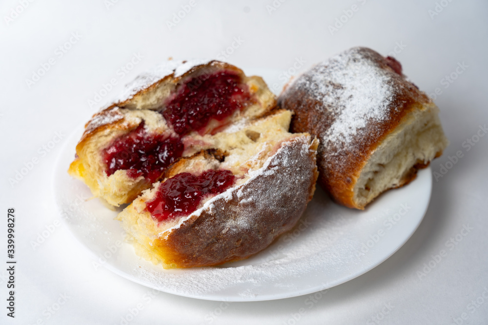 Sweet buns on a dish. Baked hot homemade buns. Isolated on a white background Sweet buns on a dish. Baked hot homemade buns. Isolated on a white background