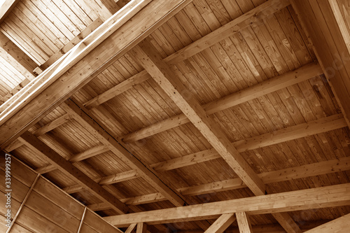 The construction of the wooden roof. Detailed photo of a wooden roof overlap construction.