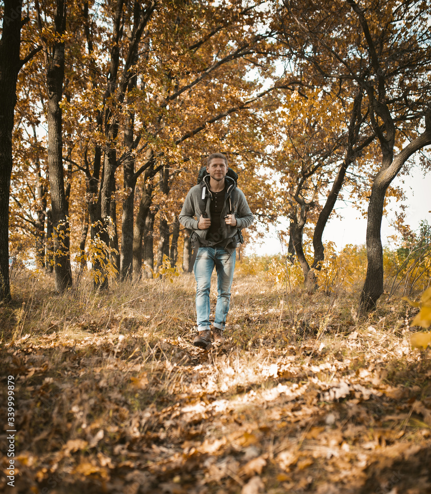 Backpacker Walks Along In Autumn Forest Backpacker Walks Along In Autumn Forest