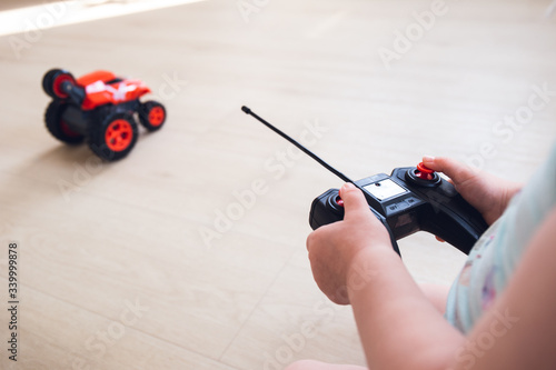 child plays with a remote control car 