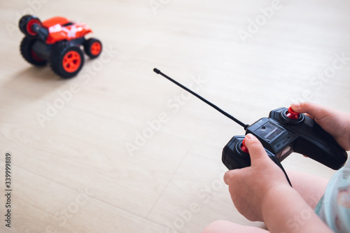 child plays with a remote control car 