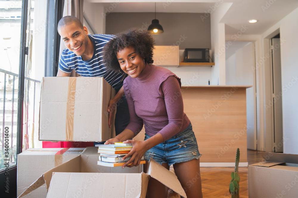 Latin couple unpacking at their new house. Latin couple unpacking at their new house.
