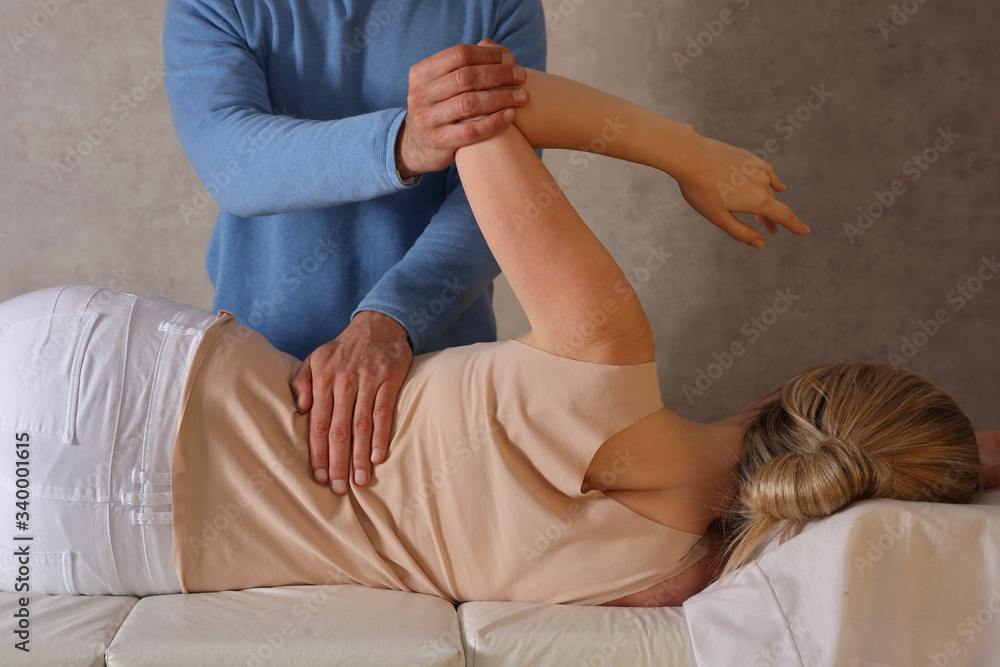 Woman having Chiropractic Back Adjustment / Physiotherapy Treatment . Scoliosis Posture Correction for Female Patient .