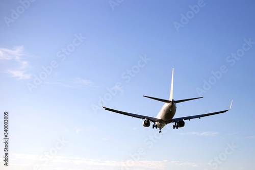 Airplane on a background of blue sky. The plane is landing. The plane takes off.