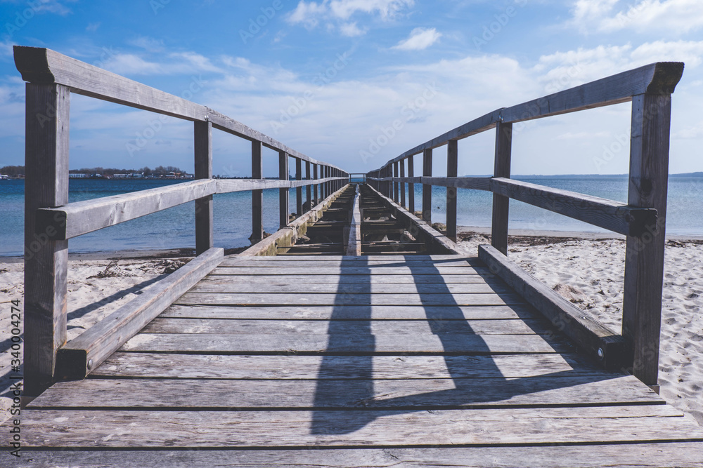 old broken wooden pier on the European sea