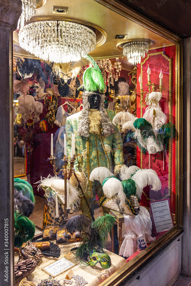 Old town of Venice. A showcase of a souvenir shop with masks on a narrow street away from Piazza San Marco in Venice, Italy Old town of Venice. A showcase of a souvenir shop with masks on a narrow street away from Piazza San Marco in Venice, Italy