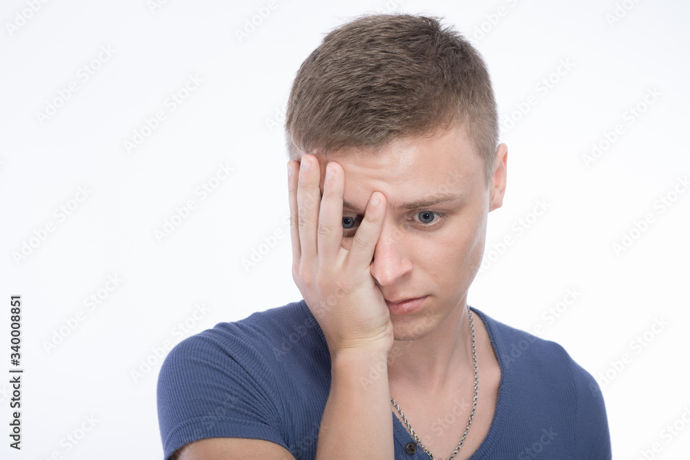 Sad young man covered his face with his hand Sad young man covered his face with his hand