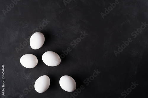 white eggs on a black background, minimalism for easter