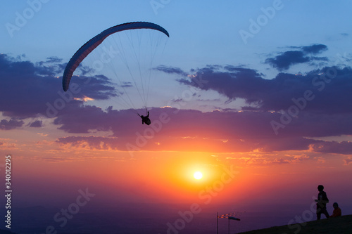 Paragliding silhouette at sunset, adventure concept. Minas Gerais, Brazil.