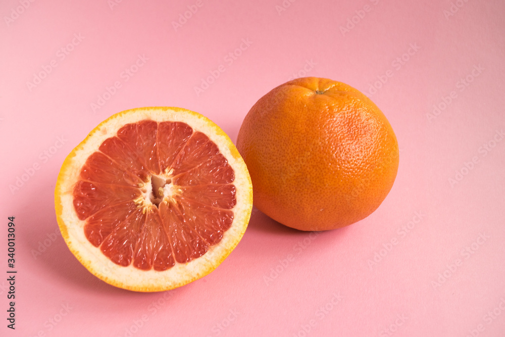 Grapefruit sliced on pink background. Minimal fruit concept Grapefruit sliced on pink background. Minimal fruit concept