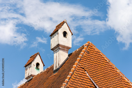 Rotes Walmdach des historischen Pfarrhauses in Rettenbach-Remshart bei Günzburg, Bayern photo