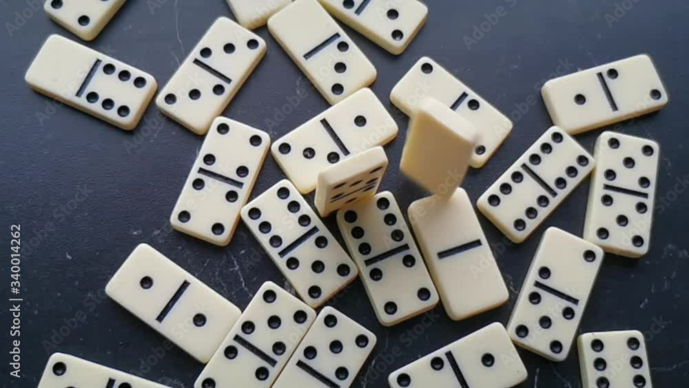 white dominoes with black dots on a dark background white dominoes with black dots on a dark background