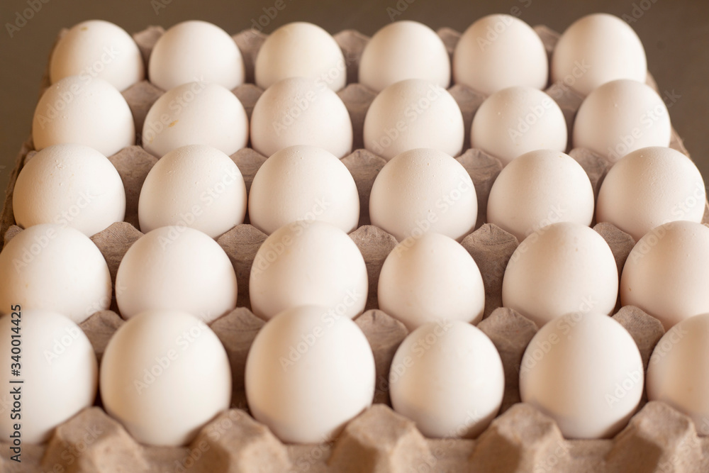 Fresh organic white eggs on the kitchen table - egg carton Fresh organic white eggs on the kitchen table - egg carton