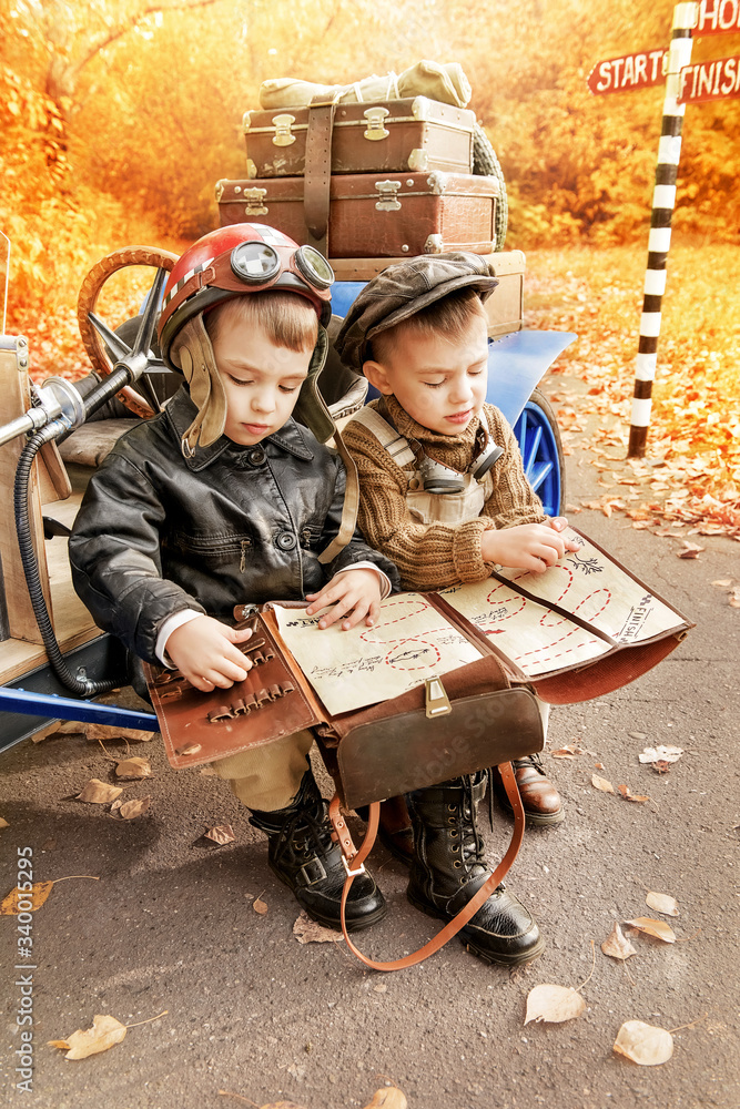 Young racer and mechanic near an old race car Young racer and mechanic near an old race car
