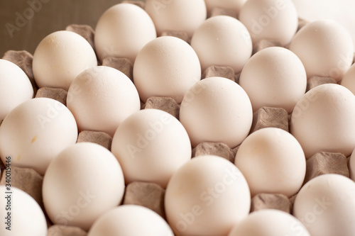 Fresh organic white eggs on the kitchen table - egg carton