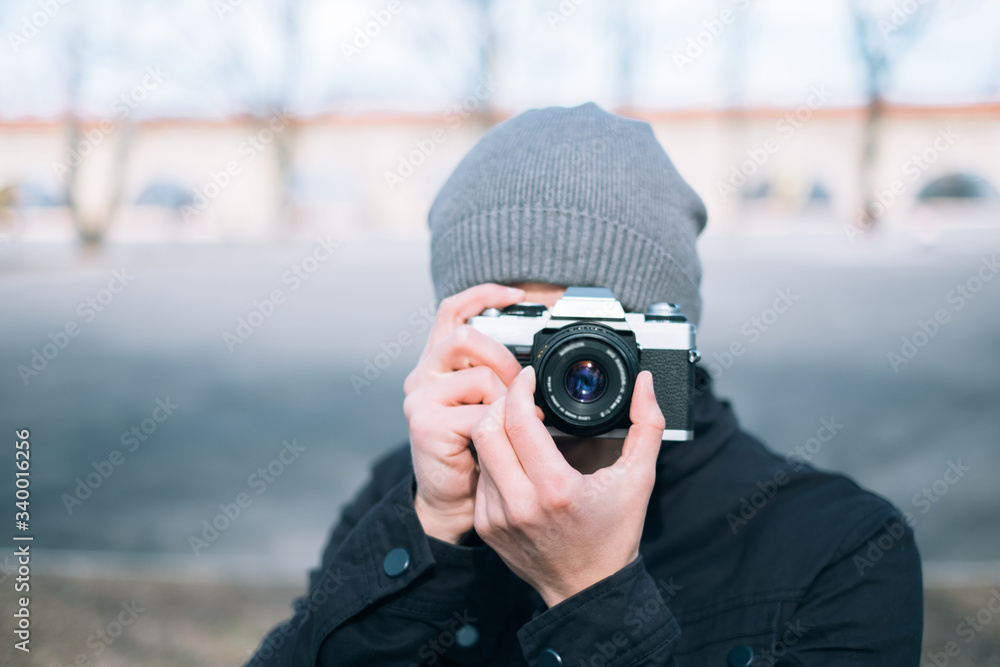 thoughtful male photographer with a camera on street thoughtful male photographer with a camera on street