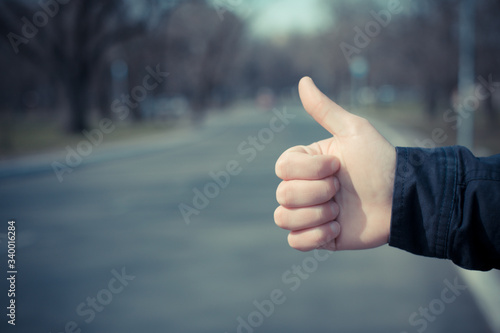 Hitchhiking youngster quite desperate to get a lift